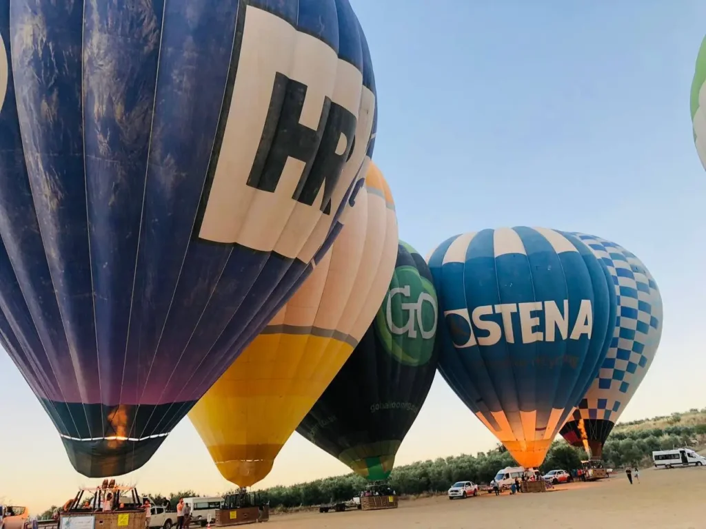 Hot air balloons flying over Pamukkale at sunrise
